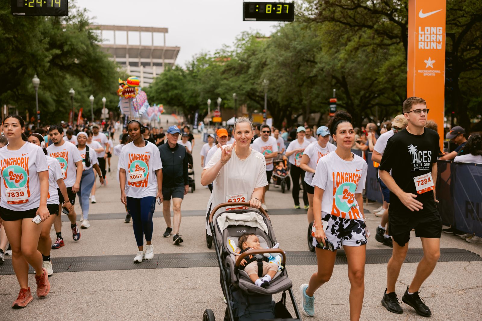 Arna Erega running a community race while pushing a stroller